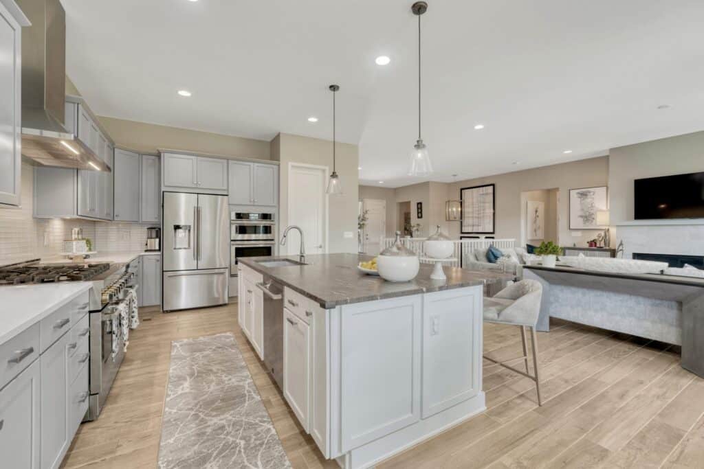 Former builder model home at 14393 Hop Clover Trail in Trails at Crowfoot, Parker Colorado, with a three-car garage.