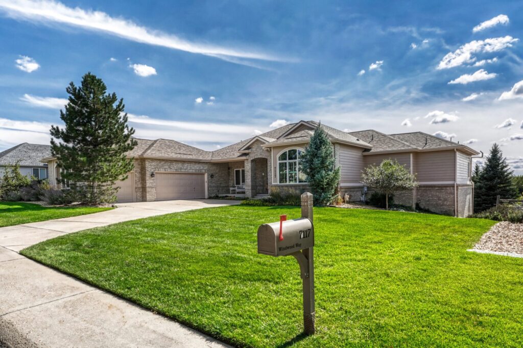 Custom walkout ranch at 7117 Windwood Way in Parker Colorado with unobstructed Pikes Peak and mountain views.